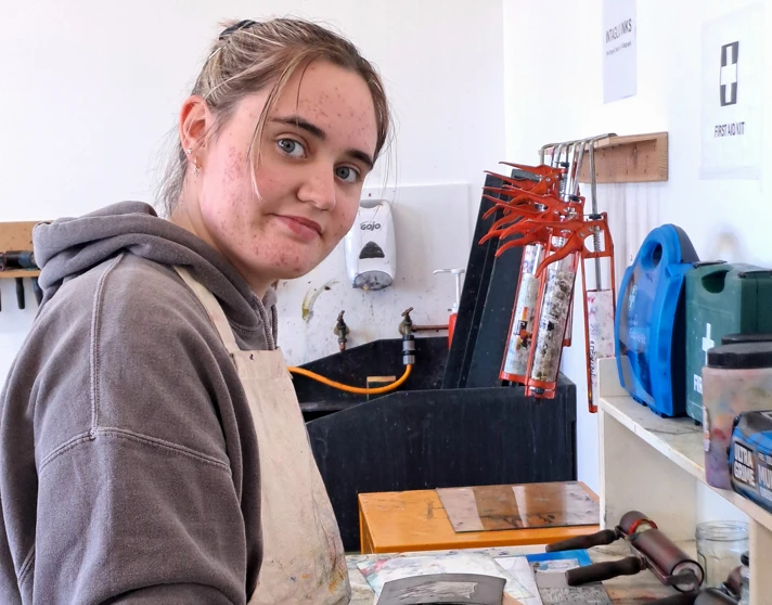 Art student using a roller to apply ink during a printmaking session at Glasgow Kelvin College Art student using a roller to apply ink during a printmaking session at Glasgow Kelvin College